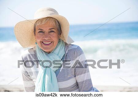 Portrait of senior woman relaxing on beach, smiling View Large Photo Image Stock Image - Portrait of senior woman relaxing on beach, smiling. Fotosearch
