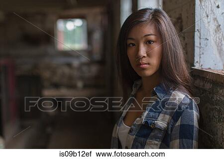 Portrait of sullen teenage girl leaning against dusty shed wall View Large Photo Image Stock Image - Portrait of sullen teenage girl leaning against dusty shed wall. Fotosearch