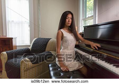 Portrait of sullen teenage girl pianist sitting at piano View Large Photo Image Picture - Portrait of sullen teenage girl pianist sitting at piano. Fotosearch