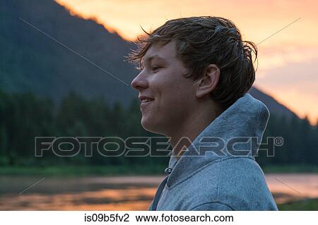 Portrait of teenage boy by river at sunset, Washington, USA View Large Photo Image Stock Image - Portrait of teenage boy by river at sunset, Washington, USA. Fotosearch