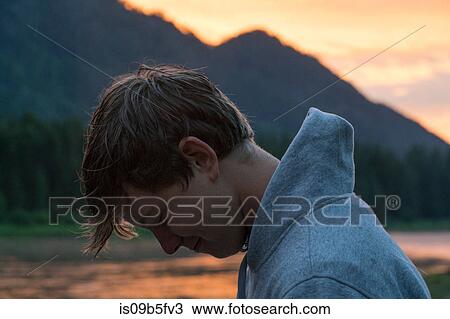 Portrait of teenage boy by river at sunset, Washington, USA View Large Photo Image Stock Image - Portrait of teenage boy by river at sunset, Washington, USA. Fotosearch