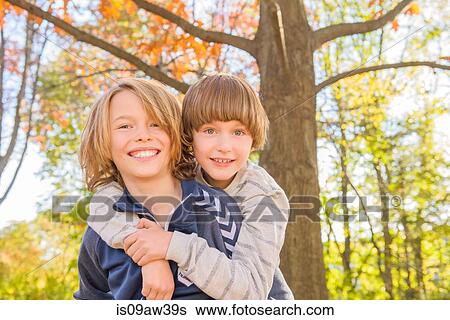 Stock Photograph - Portrait of two brothers in forest. Fotosearch