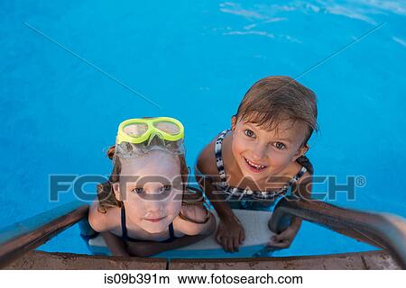 Picture - Portrait of two girls in swimming pool. Fotosearch