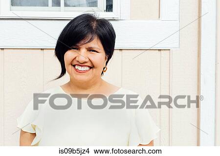 Portrait of woman looking at camera smiling View Large Photo Image Picture - Portrait of woman looking at camera smiling. Fotosearch