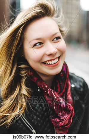 Stock Image - Portrait of woman looking away smiling. Fotosearch