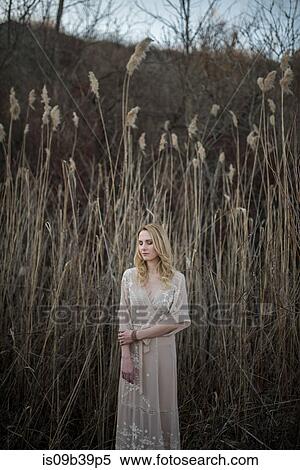 Portrait of woman, tall grass field in background, Ottawa, Ontario View Large Photo Image Stock Photography - Portrait of woman, tall grass field in background, Ottawa, Ontario. Fotosearch
