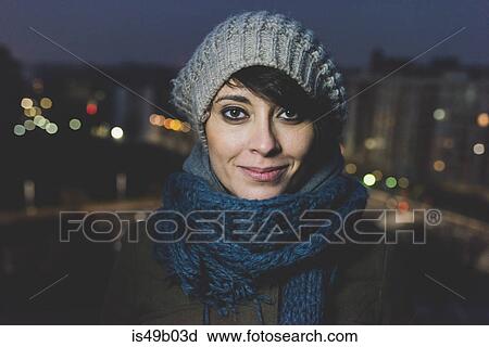 Portrait of woman wearing knit hat in city at night View Large Photo Image Stock Image - Portrait of woman wearing knit hat in city at night. Fotosearch