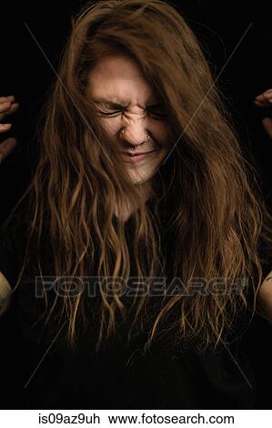 Portrait of woman with long brunette hair, eyes closed making face View Large Photo Image Stock Image - Portrait of woman with long brunette hair, eyes closed making face. Fotosearch