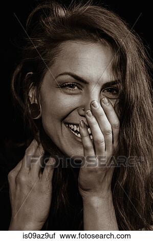 Portrait of woman with piercings, hand over mouth, looking at camera smiling View Large Photo Image Stock Image - Portrait of woman with piercings, hand over mouth, looking at camera smiling. Fotosearch
