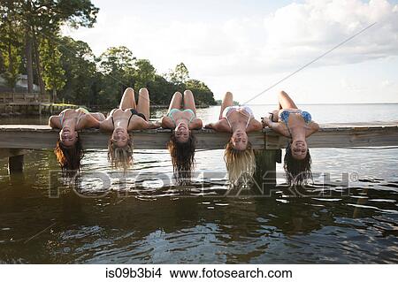 Portrait of women lying back on pier dangling long wet hair, Santa Rosa Beach, Florida, USA View Large Photo Image Picture - Portrait of women lying back on pier dangling long wet hair, Santa Rosa Beach, Florida, USA. Fotosearch