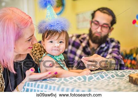 Portrait of young adult parents with baby son at first birthday party View Large Photo Image Stock Image - Portrait of young adult parents with baby son at first birthday party. Fotosearch