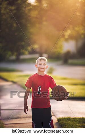 Portrait of young boy holding basketball View Large Photo Image Stock Image - Portrait of young boy holding basketball. Fotosearch