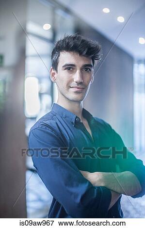 Stock Photo - Portrait of young businessman, smiling. Fotosearch