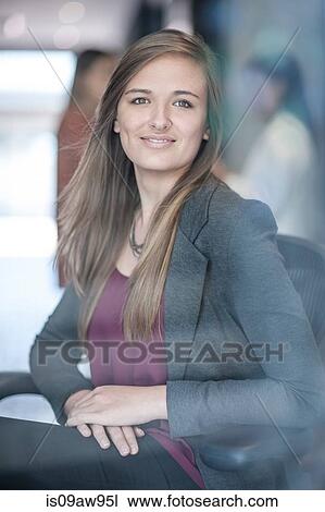 Portrait of young businesswoman, smiling View Large Photo Image Stock Image - Portrait of young businesswoman, smiling. Fotosearch