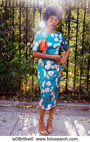 Portrait of young female fashion blogger with afro hair waiting on park sidewalk, New York, USA View Large Photo Image Stock Image - Portrait of young female fashion blogger with afro hair waiting on park sidewalk, New York, USA. Fotosearch