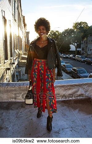 Portrait of young female fashion blogger on sunlit terrace, New York, USA View Large Photo Image Stock Image - Portrait of young female fashion blogger on sunlit terrace, New York, USA. Fotosearch