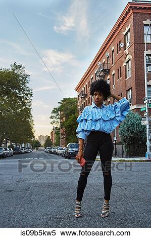 Stock Photography - Portrait of young female fashion blogger on urban street, New York, USA. Fotosearch