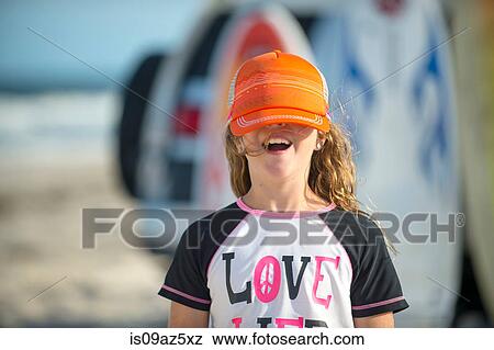 Portrait of young girl at beach, cap covering eyes View Large Photo Image Stock Photo - Portrait of young girl at beach, cap covering eyes. Fotosearch