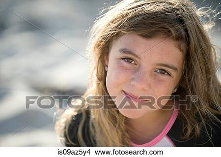 Portrait of young girl at beach, smiling View Large Photo Image Picture - Portrait of young girl at beach, smiling. Fotosearch