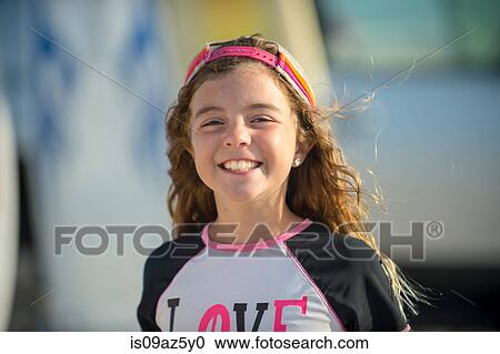 Portrait of young girl at beach, smiling View Large Photo Image Stock Image - Portrait of young girl at beach, smiling. Fotosearch