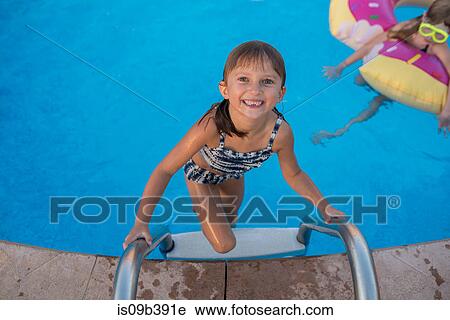 Portrait of young girl climbing out of swimming pool View Large Photo Image Stock Image - Portrait of young girl climbing out of swimming pool. Fotosearch