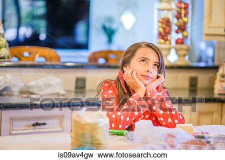 Portrait of young girl in kitchen, head resting in hands View Large Photo Image Stock Photo - Portrait of young girl in kitchen, head resting in hands. Fotosearch
