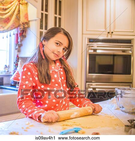 Portrait of young girl in kitchen, using rolling pin View Large Photo Image Stock Image - Portrait of young girl in kitchen, using rolling pin. Fotosearch