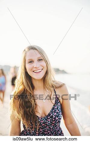 Portrait of young long haired blonde woman looking at camera smiling View Large Photo Image Stock Photograph - Portrait of young long haired blonde woman looking at camera smiling. Fotosearch