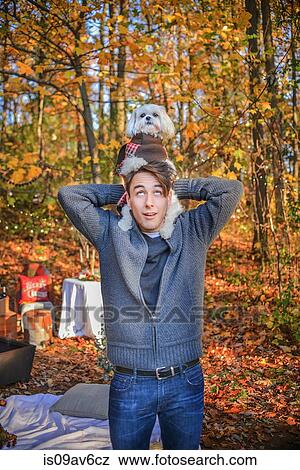 Portrait of young man carrying dog on shoulders in woods View Large Photo Image Stock Photo - Portrait of young man carrying dog on shoulders in woods. Fotosearch