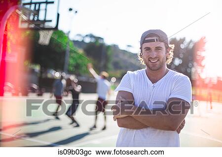 Portrait of young man on basketball court View Large Photo Image Stock Image - Portrait of young man on basketball court. Fotosearch