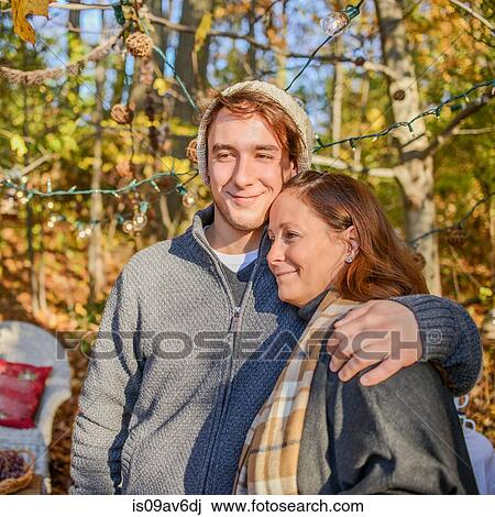 Portrait of young man with arm around mother in woods View Large Photo Image Stock Image - Portrait of young man with arm around mother in woods. Fotosearch