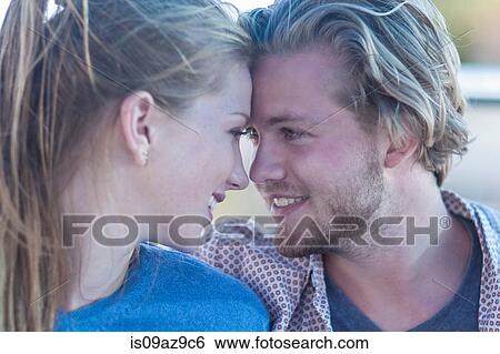 Stock Photograph - Portrait of young tourist couple face to face on boat trip, Cape Town, South Africa. Fotosearch