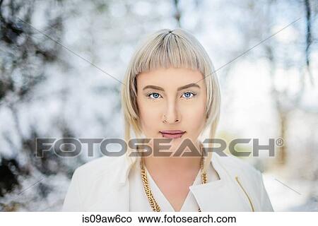 Picture - Portrait of young woman against winter landscape. Fotosearch