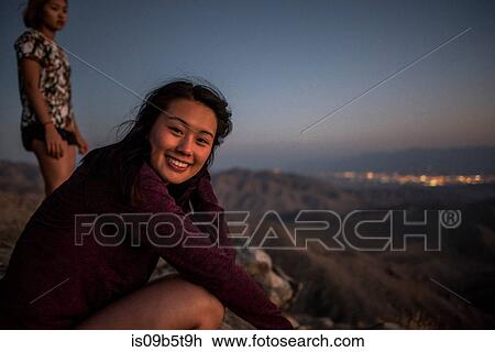Stock Image - Portrait of young woman and friend in Joshua Tree National Park at sunset, California, USA. Fotosearch