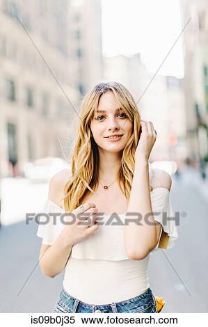 Portrait of young woman, blonde hair, outdoors View Large Photo Image Stock Photography - Portrait of young woman, blonde hair, outdoors. Fotosearch