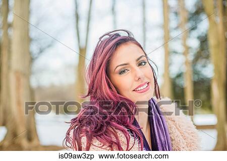 Stock Photography - Portrait of young woman outdoors, smiling. Fotosearch