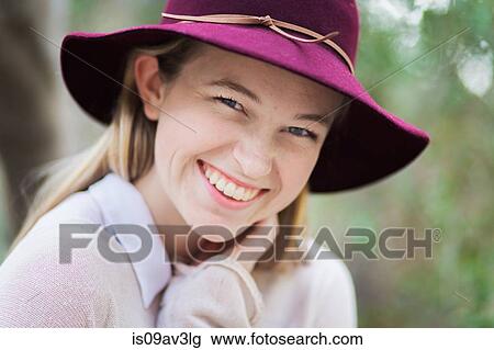 Portrait of young woman, smiling, outdoors View Large Photo Image Stock Image - Portrait of young woman, smiling, outdoors. Fotosearch