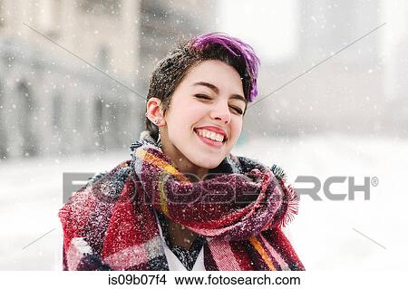 Picture - Portrait of young woman standing in front of the Christian Science Centre and Prudential building with snow, Boston, Massachusetts, USA. Fotosearch