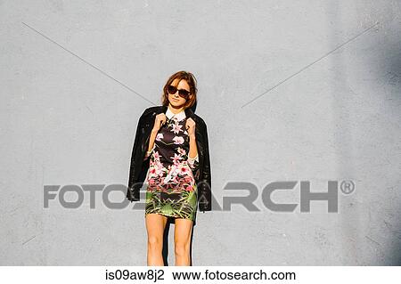 Portrait of young woman, wearing dress and leather jacket, outdoors View Large Photo Image Stock Image - Portrait of young woman, wearing dress and leather jacket, outdoors. Fotosearch