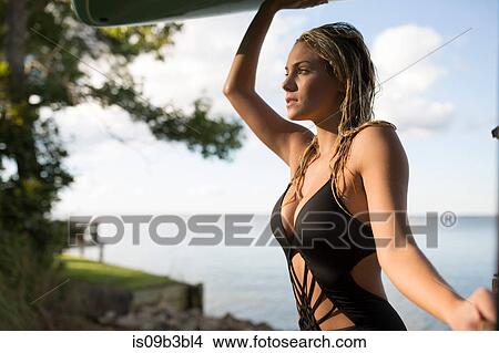 Picture - Portrait of young woman with blond hair in swimsuit at coast, Santa Rosa Beach, Florida, USA. Fotosearch