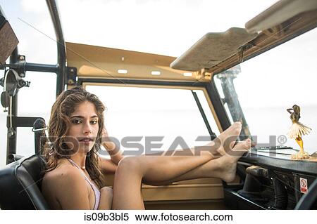 Portrait of young woman with feet up in convertible vehicle at coast, Santa Rosa Beach, Florida, USA View Large Photo Image Stock Photography - Portrait of young woman with feet up in convertible vehicle at coast, Santa Rosa Beach, Florida, USA. Fotosearch