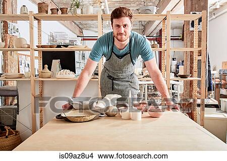 Potter in workshop with pottery View Large Photo Image Picture - Potter in workshop with pottery. Fotosearch