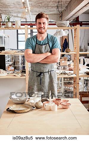 Potter in workshop with pottery View Large Photo Image Stock Photography - Potter in workshop with pottery. Fotosearch