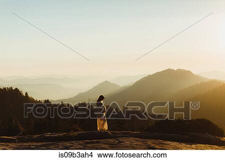 Pregnant woman in mountains touching stomach, Sequoia national park, California, USA View Large Photo Image Picture - Pregnant woman in mountains touching stomach, Sequoia national park, California, USA. Fotosearch