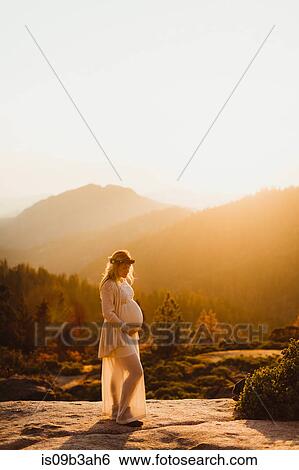 Pregnant woman in mountains touching stomach, Sequoia national park, California, USA View Large Photo Image Stock Photograph - Pregnant woman in mountains touching stomach, Sequoia national park, California, USA. Fotosearch