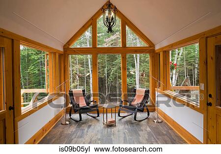 Reading room with ceramic tile floor and two black leather rocking chairs in cottage-style log cabin, Quebec, Canada View Large Photo Image Stock Image - Reading room with ceramic tile floor and two black leather rocking chairs in cottage-style log cabin, Quebec, Canada. Fotosearch