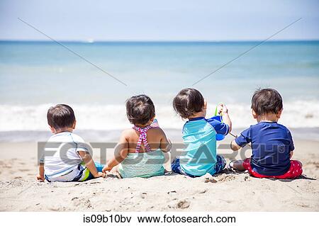 Rear view of baby girl and three baby boys sitting on beach, Malibu, California, USA View Large Photo Image Stock Photo - Rear view of baby girl and three baby boys sitting on beach, Malibu, California, USA. Fotosearch