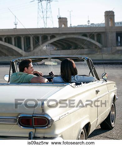 Rear view of couple in convertible classic car, Los Angeles, California, USA View Large Photo Image Stock Photo - Rear view of couple in convertible classic car, Los Angeles, California, USA. Fotosearch