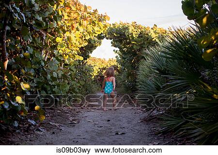 Rear view of girl wearing bathing costume exploring park, Blowing Rocks Preserve, Jupiter Island, Florida, USA View Large Photo Image Stock Photo - Rear view of girl wearing bathing costume exploring park, Blowing Rocks Preserve, Jupiter Island, Florida, USA. Fotosearch