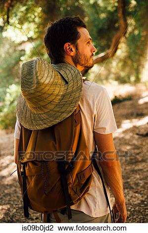 Rear view of hiker with backpack and sunhat looking away, Malibu Canyon, California, USA View Large Photo Image Stock Image - Rear view of hiker with backpack and sunhat looking away, Malibu Canyon, California, USA. Fotosearch